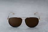 Gold aviator style sunglasses with dark brown lenses  open, facing forward.