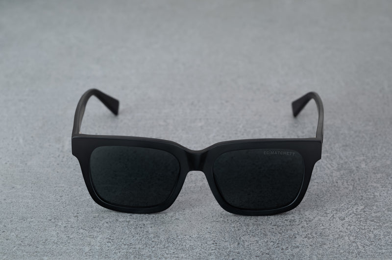 Black sunglasses with black lenses, facing forward with temples open.