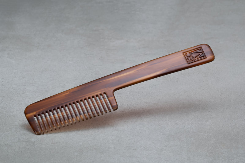 8.5 inch (4.5 inch handle) comb made of red-brown Italian acetate.