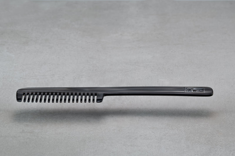 8.5 inch (4.5 inch handle) comb made of black, and silver Italian acetate.