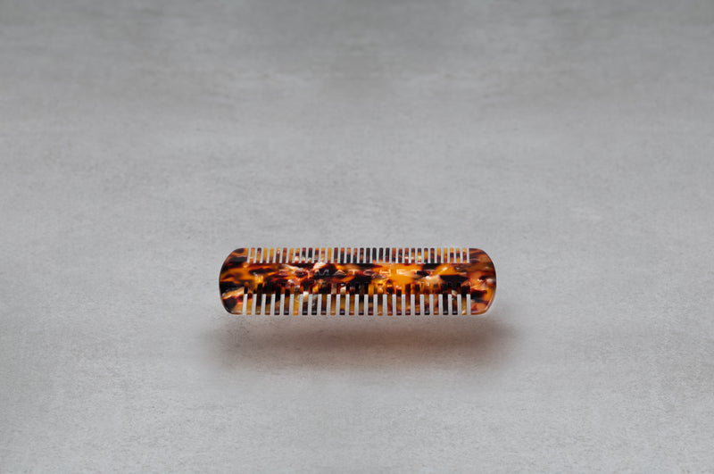 4 inch beard comb made of red, black, and amber Italian acetate.