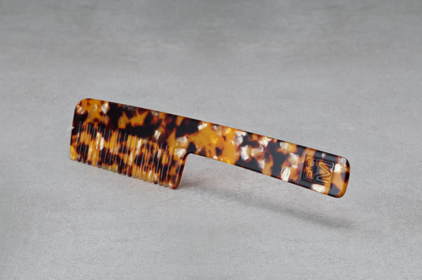 8.5 inch (4.5 inch handle) comb made of red, black, and amber Italian acetate.