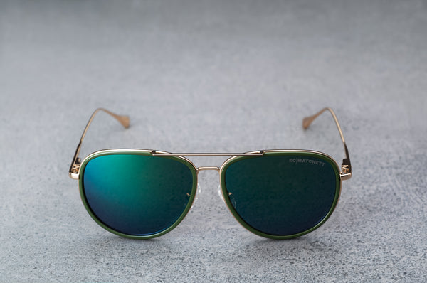 Gold aviator style sunglasses with reflective green lenses with temples open, facing forward.