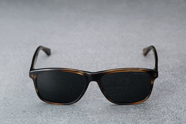 dark brown glasses with dark gray lenses, open, facing forward.